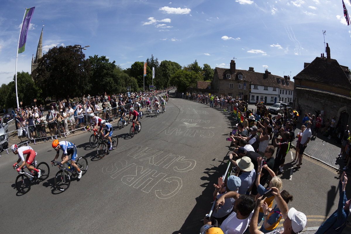 Birmingham 2022 - XXII Commonwealth Games - Men’s Road Race - Large crowds line the road as the race corners near the castle