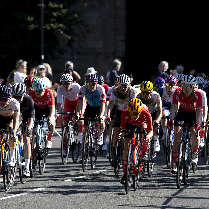 Birmingham 2022 - XXII Commonwealth Games - Women’s Road Race - The peloton races away from a medieval city gate