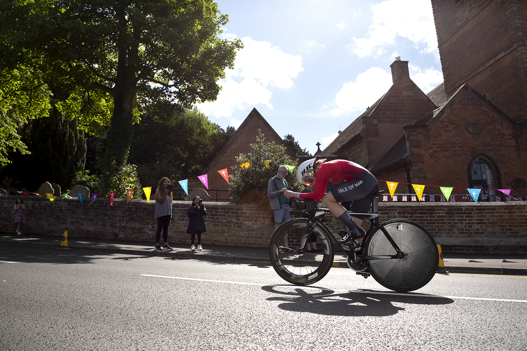 Birmingham 2022 - XXII Commonwealth Games - Women’s Time Trial - Jessica Carridge of the Isle of Man races through streets decorated with bunting as excited young fans look on