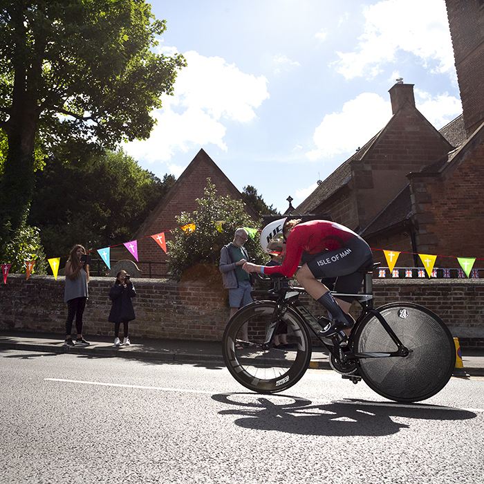 Birmingham 2022 - XXII Commonwealth Games - Women’s Time Trial - Jessica Carridge of the Isle of Man races through streets decorated with bunting as excited young fans look on