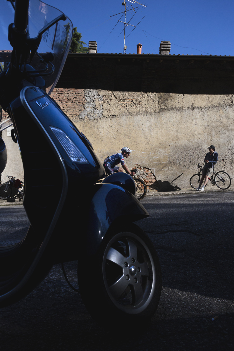 Coppa Bernocchi 2025 - Ethan Hayter is framed by a Vespa moped as he takes on the lower slopes of a climb