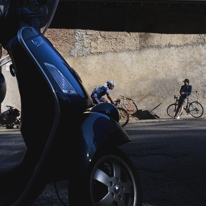 Coppa Bernocchi 2025 - Ethan Hayter is framed by a Vespa moped as he takes on the lower slopes of a climb