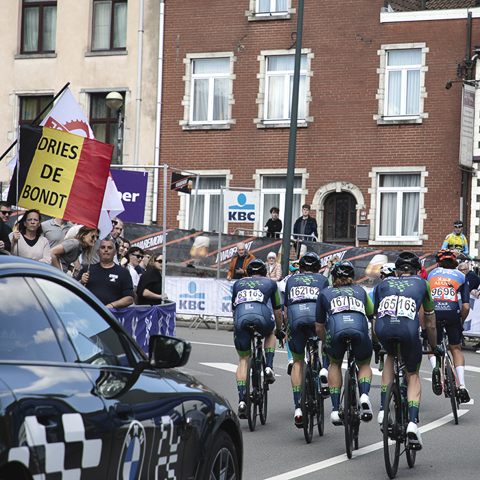 De Brabantse Pijl 2024 - The riders of Team Novo Nordisk pass a group of fans holding a Belgian tricolour with Dries de Bondt written on it
