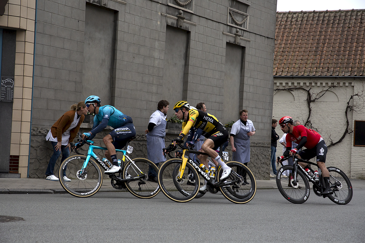 Dwars Door Vlaanderen 2022 - Victor Campanaerts of Lotto Soudal, Pascal Eenkhoorn of Jumbo-Visma and Astana Qazaqstan Team’s Davide Martinelli race through the streets