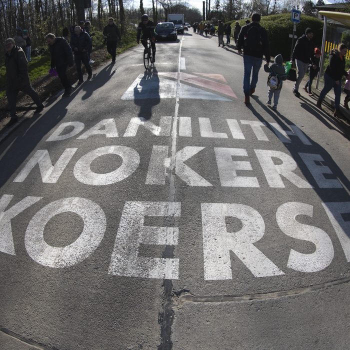 Dwars Door Vlaanderen 2024 - The logo for another race, Danlith Nokere Koerse painted on the road in Nokere