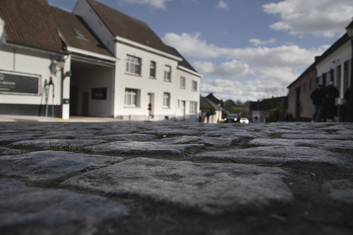 Dwars Door Vlaanderen 2024 - A low angle view of the main cobbled street through Nokere, Belgium