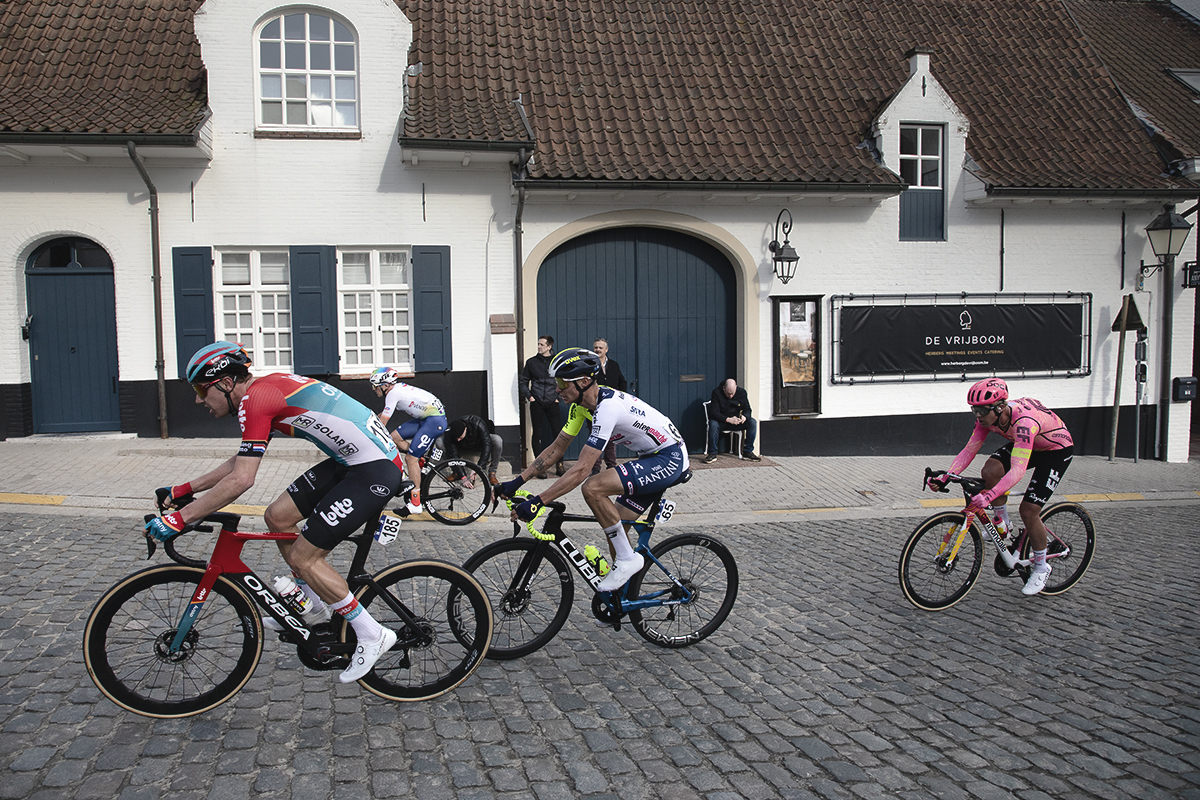 Dwars Door Vlaanderen 2024 - The breakaway passes white washed buildings in Nokere