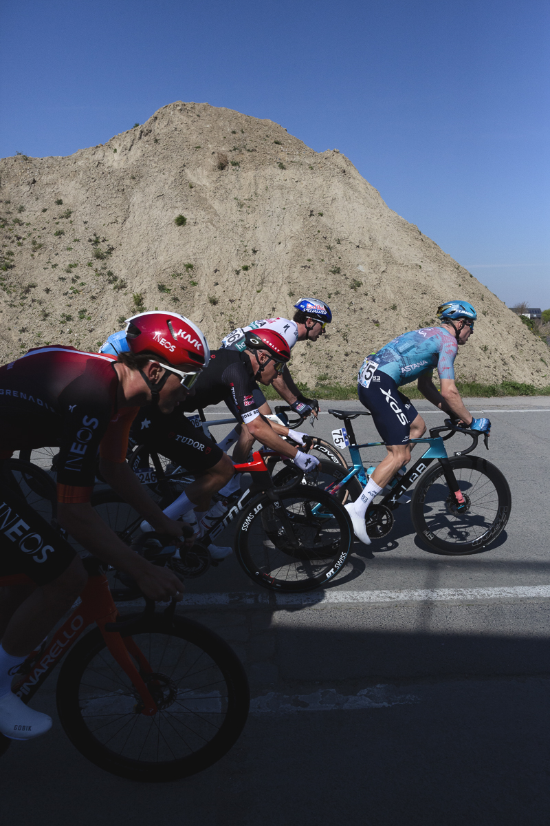 Dwars Door Vlaanderen 2025 - Riders race past the demolished remains of a factory in Vichte