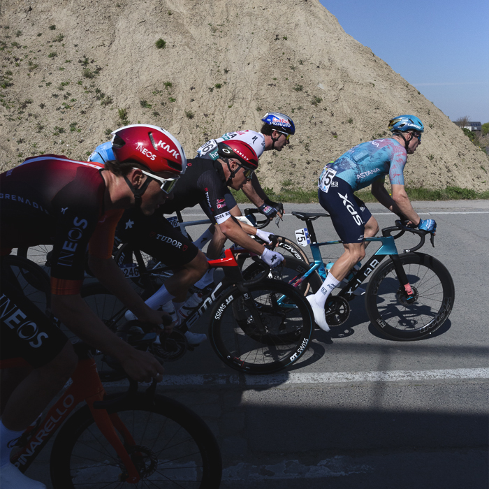 Dwars Door Vlaanderen 2025 - Riders race past the demolished remains of a factory in Vichte