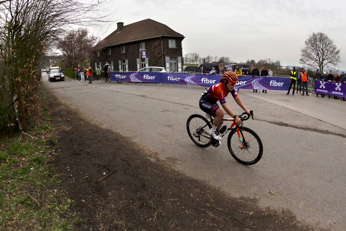 Dwars Door Vlaanderen Vrouwen 2023 - Human Powered Health rider Makayla MacPherson passes the top of Ronde van Vlaanderenstraat