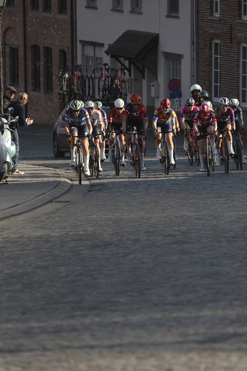 Dwars Door Vlaanderen Vrouwen 2025 - A group of riders on the cobbles in the village of Nokere