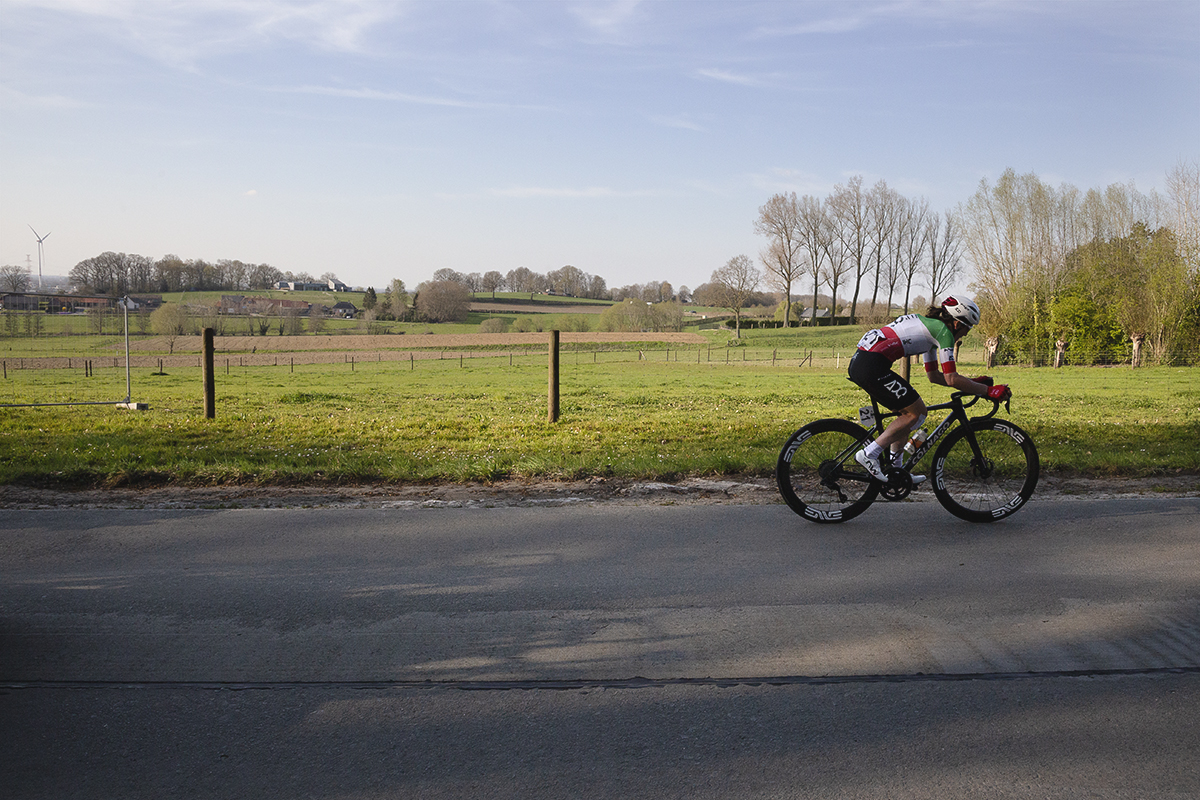 Dwars Door Vlaanderen Vrouwen 2025 - Elisa Longo Borghini with fields behind her as she leads the race