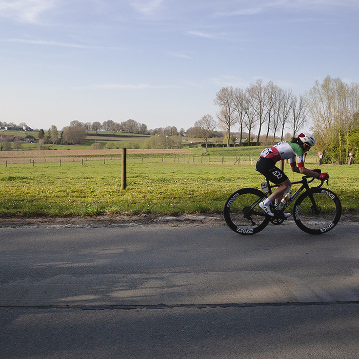 Dwars Door Vlaanderen Vrouwen 2025 - Elisa Longo Borghini with fields behind her as she leads the race