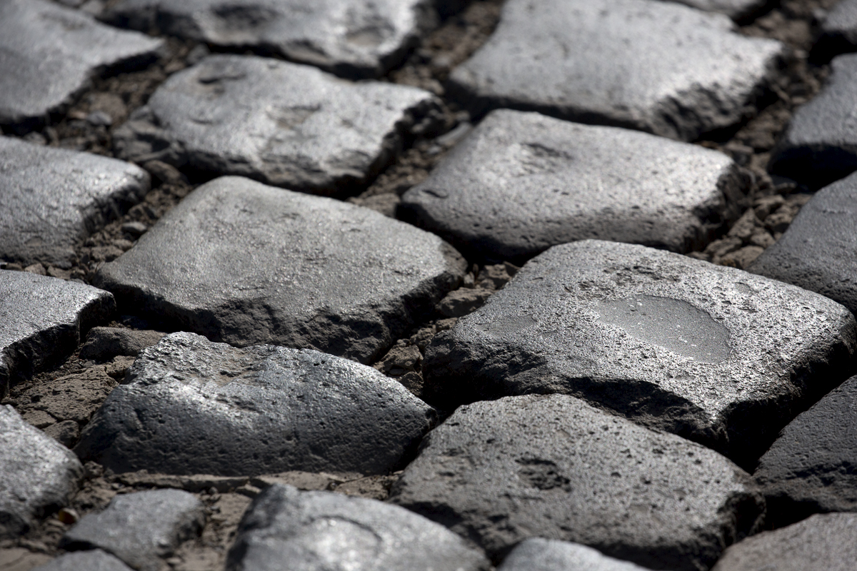 E3 Saxo Bank Classic 2022 - A close up of the rough cobbles on Holleweg glinting in the low sunlight