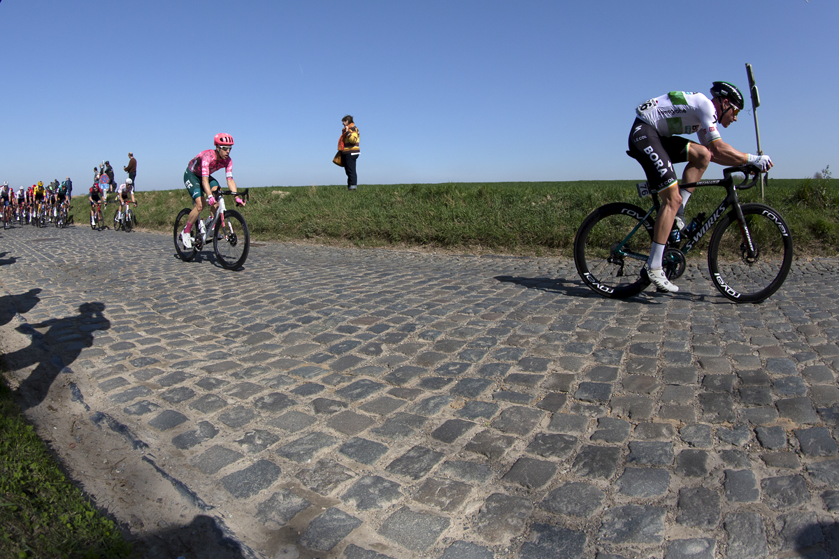 E3 Saxo Bank Classic 2022 - Ryan Mullen of Bora-hansgrobe wearing his Irish Champions jersey leads riders past fans on Holleweg