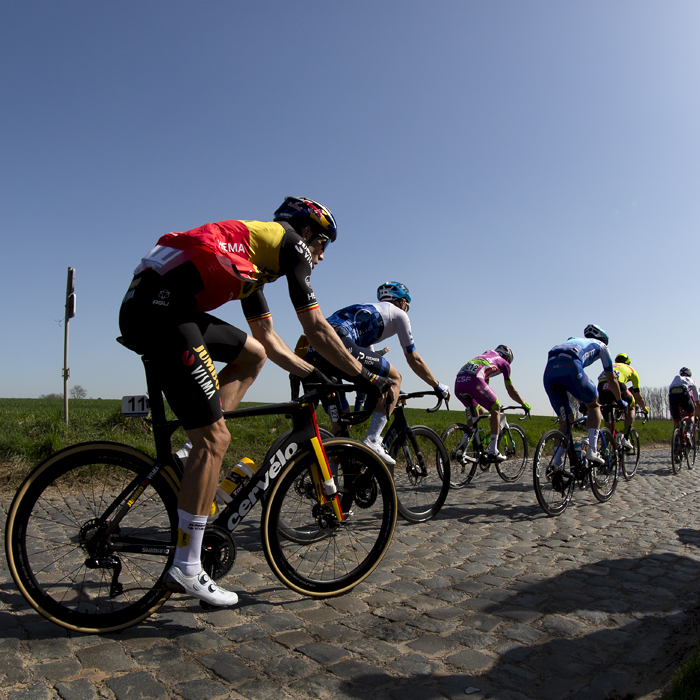 E3 Saxo Bank Classic 2022 - Supporters at the side of the road take in the action as Wout van Aert of Jumbo-Visma passes wearing the Belgium Champions jersey