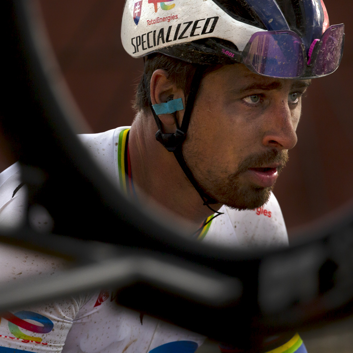 E3 Saxo Classic 2023 - Peter Sagan of TotalEnergies framed through a bike wheel