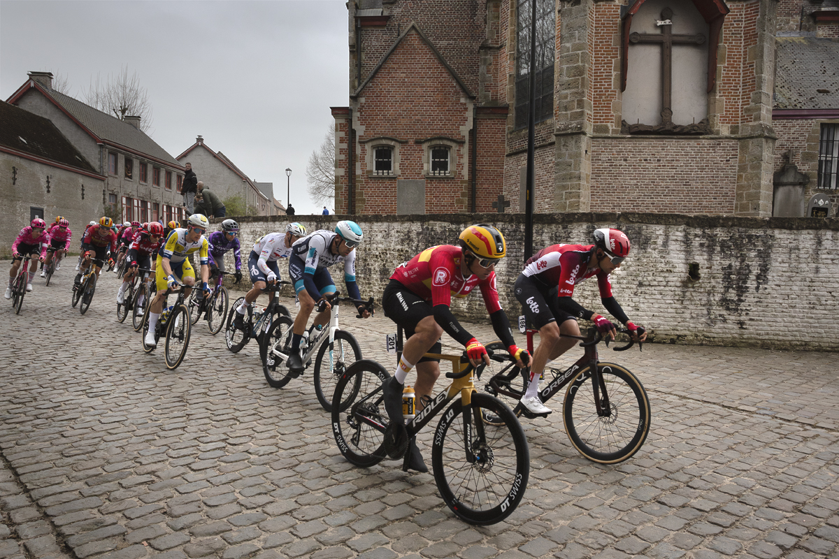 E3 Saxo Classic 2025 - Riders on the cobbles pass Sint Denijskerk