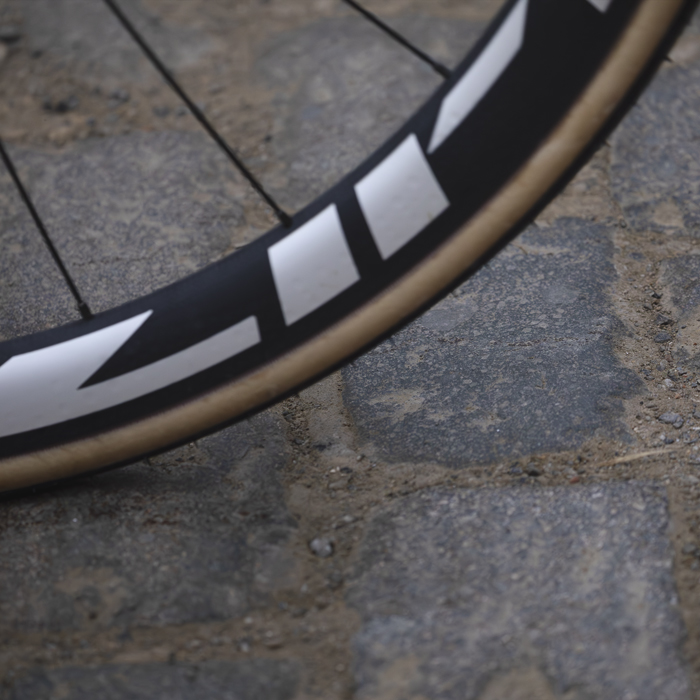 E3 Saxo Classic 2025 - A close up of a wheel on the cobbles of Stationberg