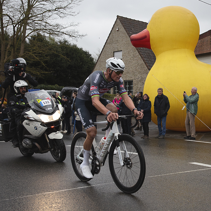 E3 Saxo Classic 2025 - Mathieu van der Poel climbs the Tiegemberg with a giant inflatable duck to one side
