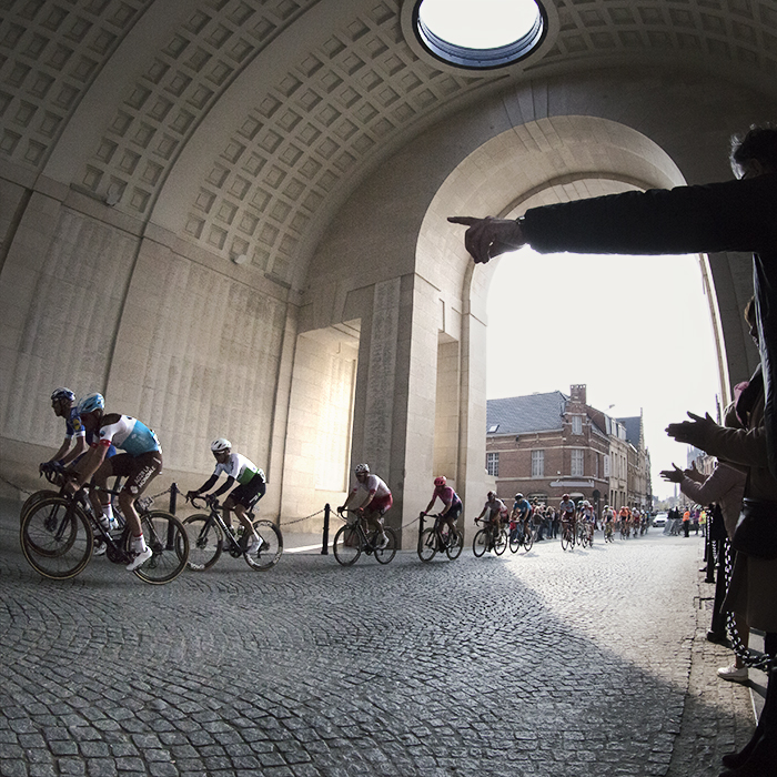 Gent Wevelgem 2019 - a fan points as the peloton passes through the Menin Gate in Ieper / Ypres