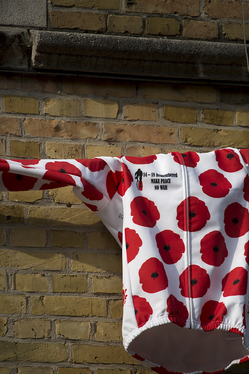 Gent Wevelgem 2019 - A jersey covered in poppies commemorating WWI hangs from a wall in Ipres.