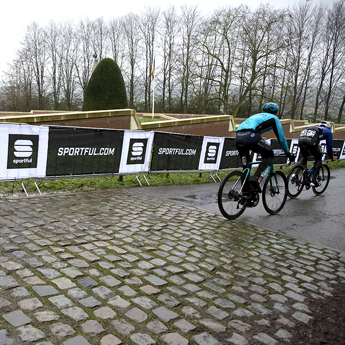 Gent - Wevelgem 2023 - A group of riders descends the Kemmelberg past the Ossuaire monument