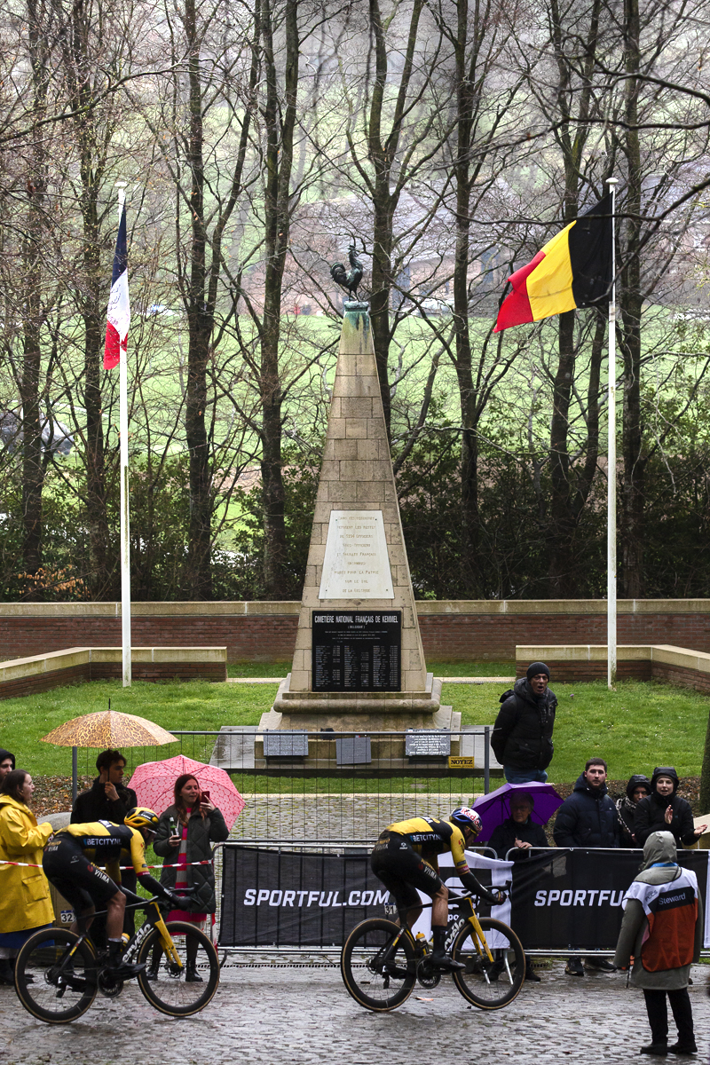 Gent - Wevelgem 2023 - Riders pass the Ossuaire monument with the French and Belgium flags flying