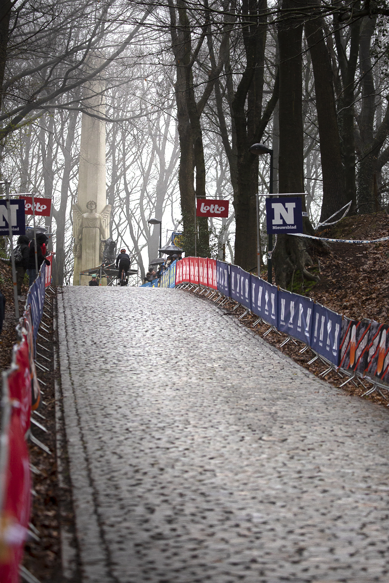 Gent - Wevelgem 2023 - View up the cobbled climb of Kemmelberg Ossuaire with the French monument, or De Engel at the top