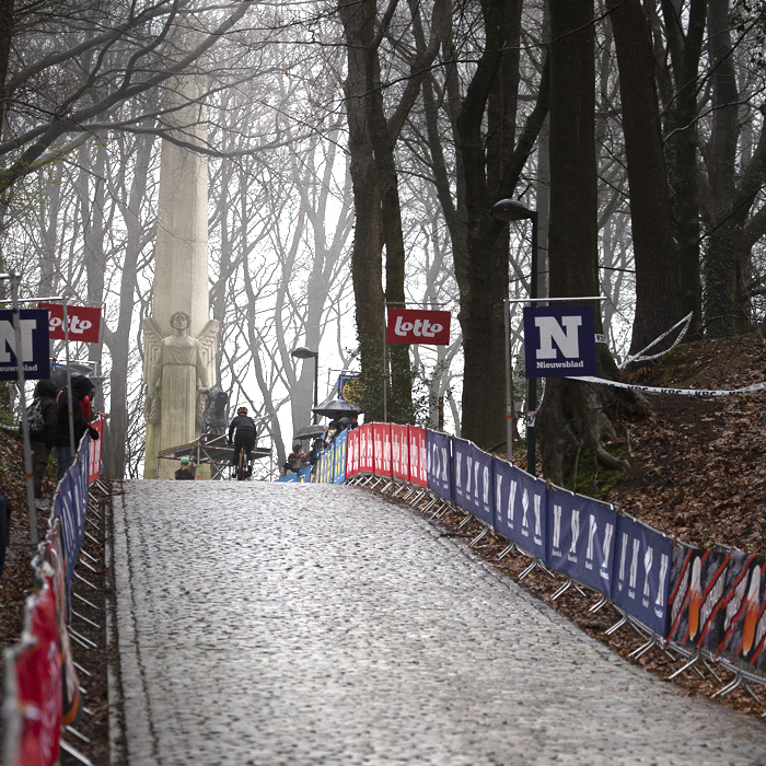 Gent - Wevelgem 2023 - View up the cobbled climb of Kemmelberg Ossuaire with the French monument, or De Engel at the top