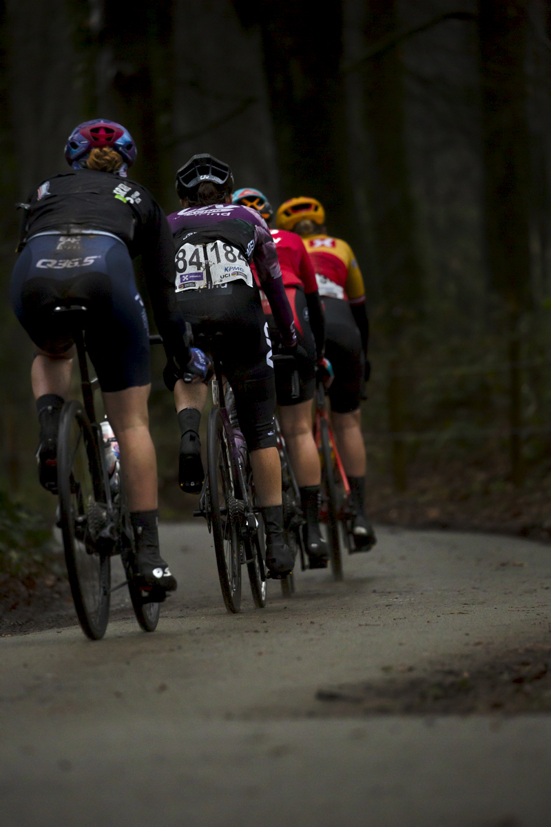 Gent - Wevelgem Vrouwen 2023 - The rear of a small group of riders finish their ascent of the Kemmelberg