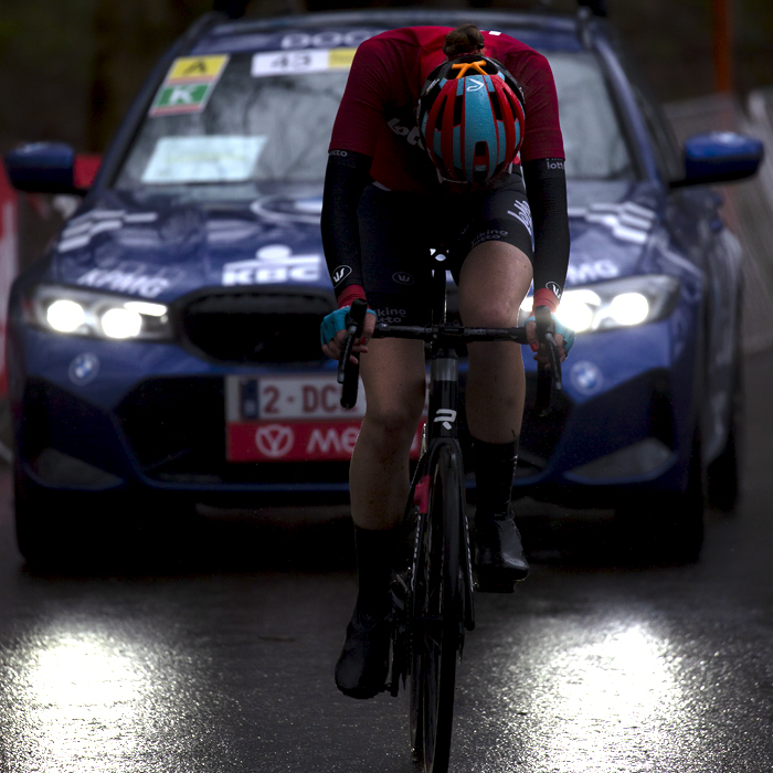 Gent - Wevelgem Vrouwen 2023 - Marla Sigmund of Lotto Dstny Ladies lit by her support car headlights hangs her head as she feels the effects of the race