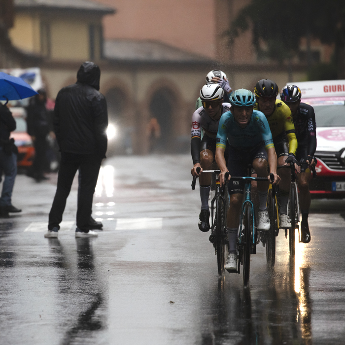 Giro dell’Emilia 2024 - Gianmarco Garofoli of Astana Qazaqstan Team leads a group past fans holding umbrellas