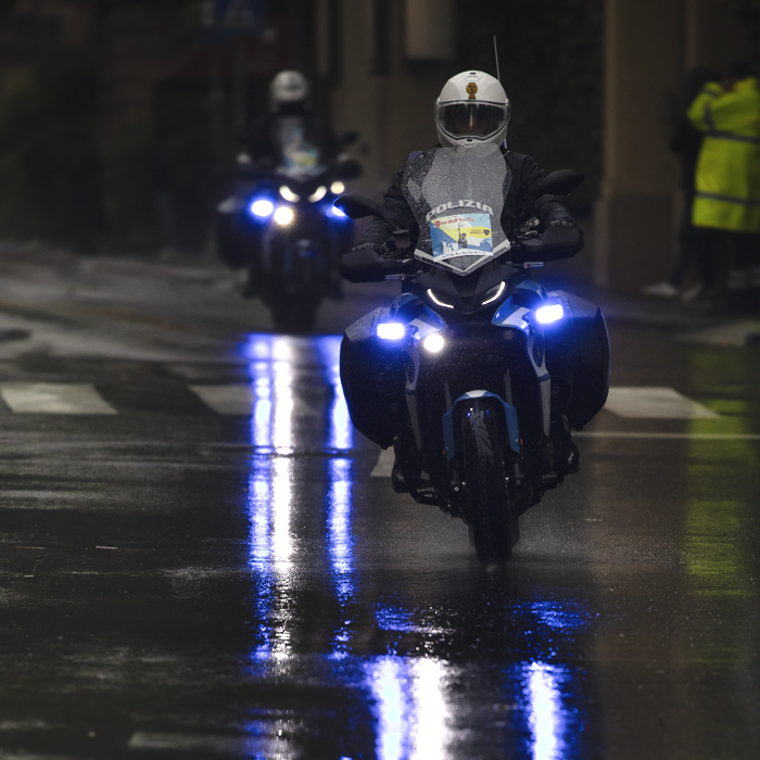 Giro dell’Emilia 2024 - Blue lights of the Polizia reflected in the wet road