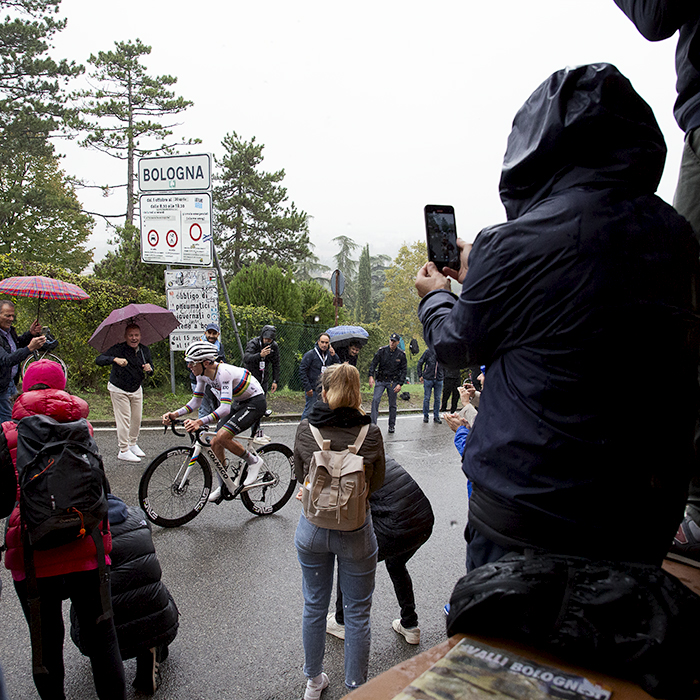 Giro dell’Emilia 2024 - Tadej Pogačar is cheered on by fans holding umbrellas on the way up the Via di San Luca