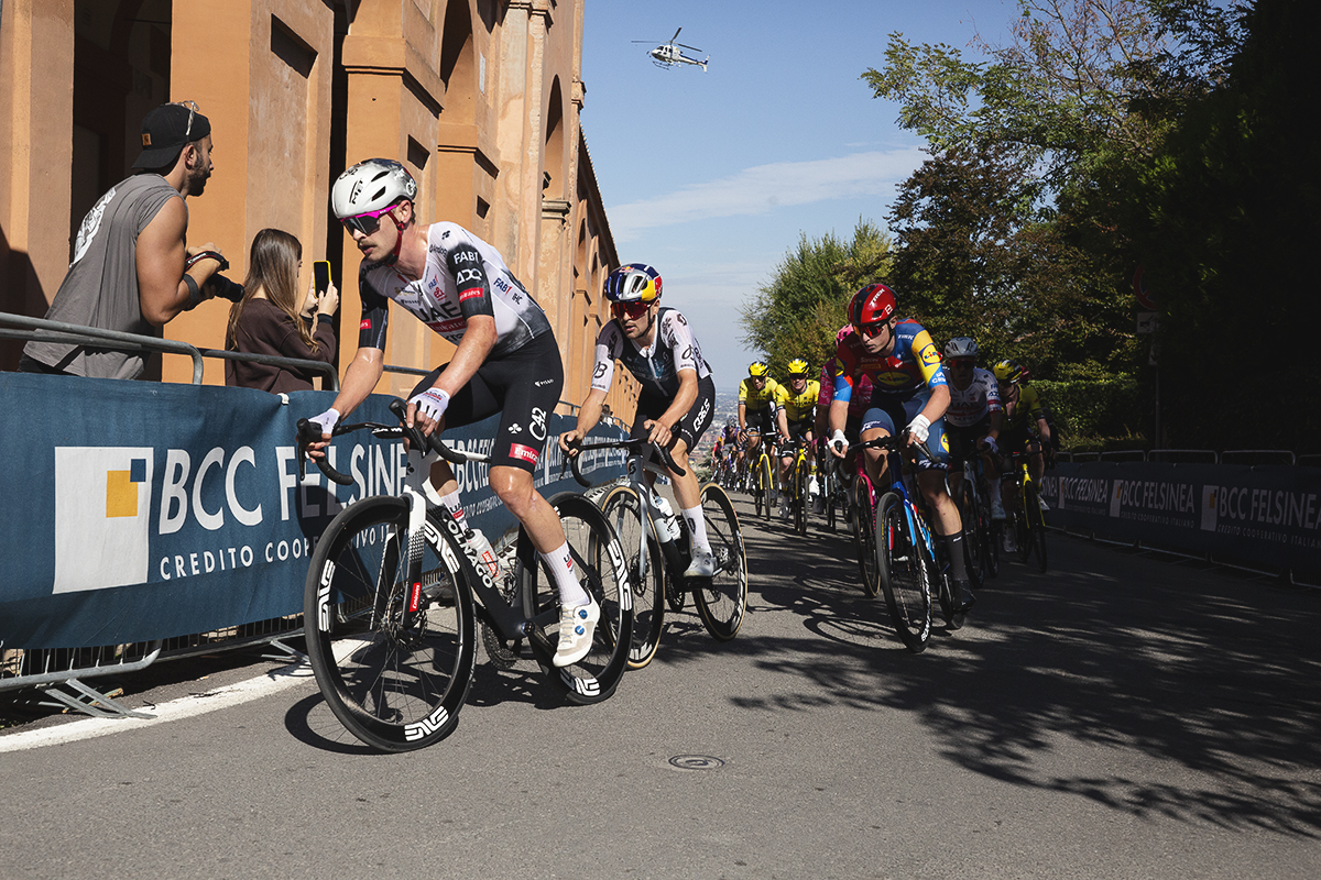 Giro dell’Emilia 2025 - Jay Vine and Tom Pidcock lead a group alongside the Portico on the San Luca Climb