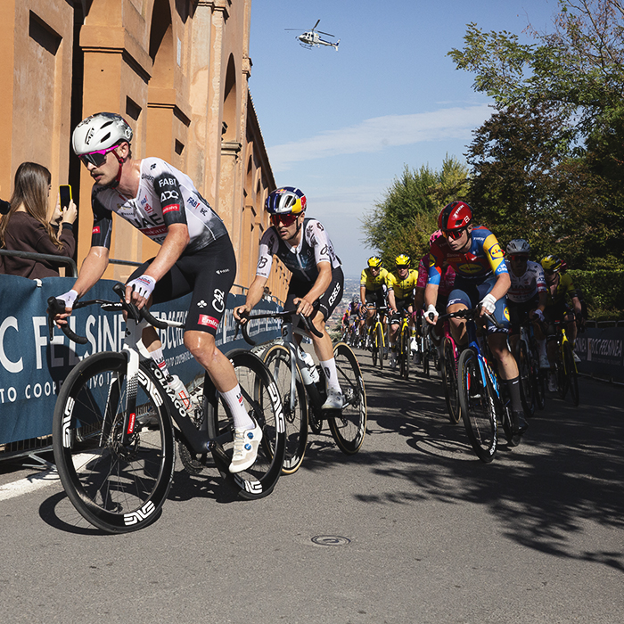 Giro dell’Emilia 2025 - Jay Vine and Tom Pidcock lead a group alongside the Portico on the San Luca Climb