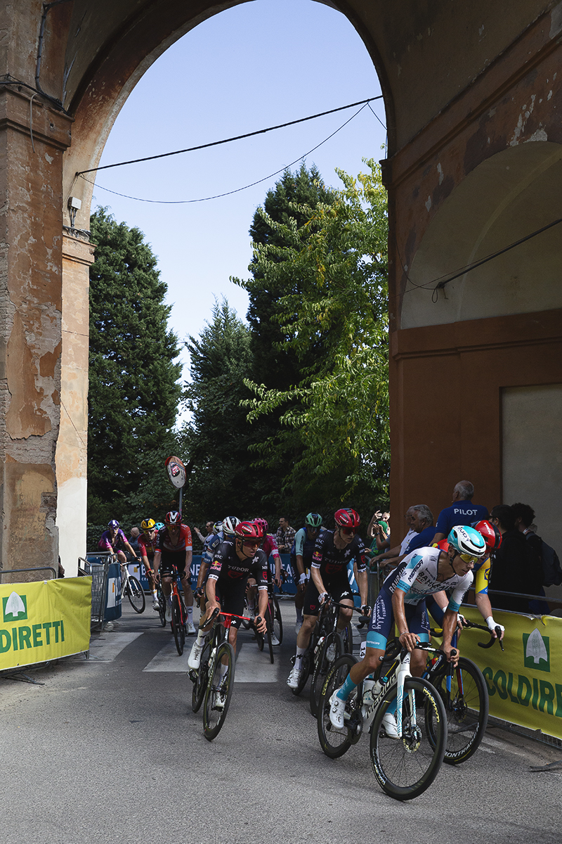 Giro dell’Emilia 2025 - The peloton passes through one of the gates on the San Luca climb