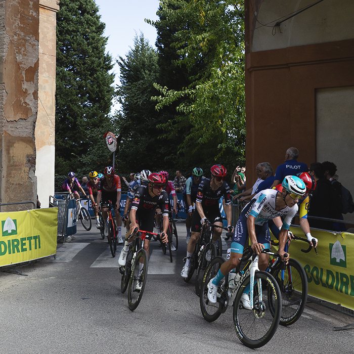 Giro dell’Emilia 2025 - The peloton passes through one of the gates on the San Luca climb