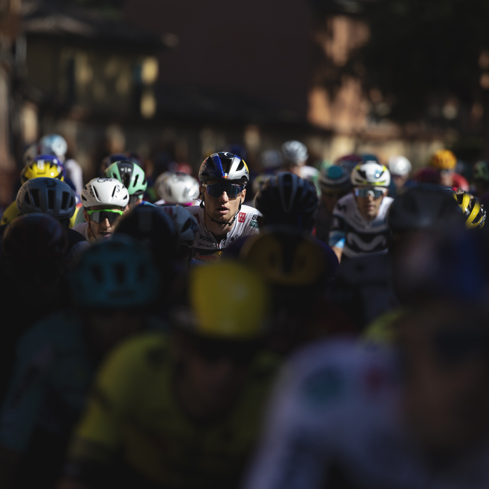 Giro dell’Emilia 2025 - Aleksandr Vlasov picked out by the light in the peloton