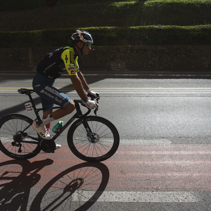 Giro dell’Emilia 2025 - Andrea Piras follows a bike path painted on the road in Bologna