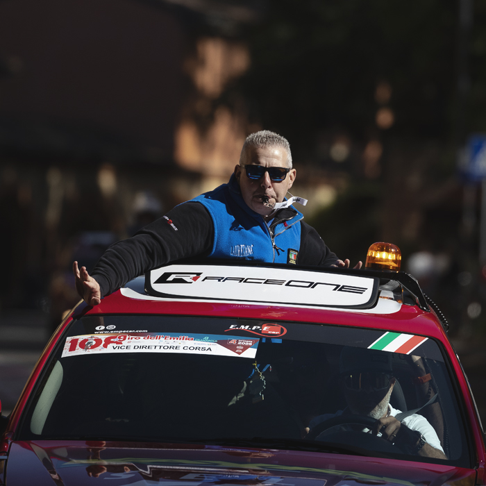Giro dell’Emilia 2025 - Vice Direttore Corsa emerges from the sun roof of a car whistle in mouth