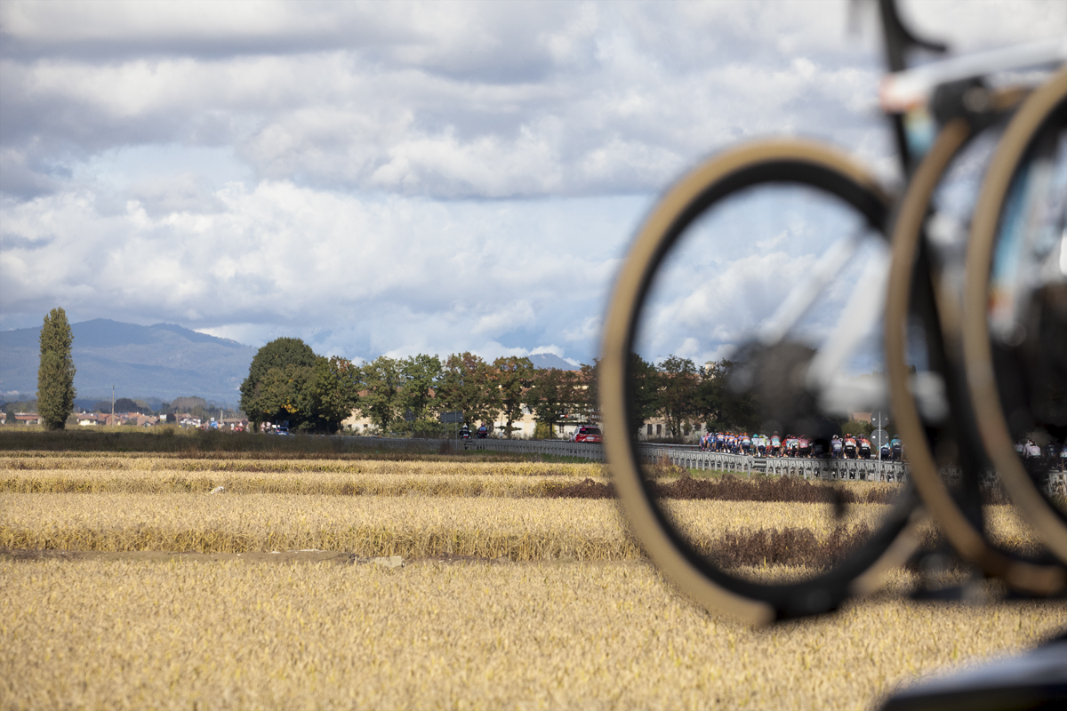 Gran Piemonte 2024 - The rice fields of Cascina Solarolo seen through a bike wheel on a team car with the race in view