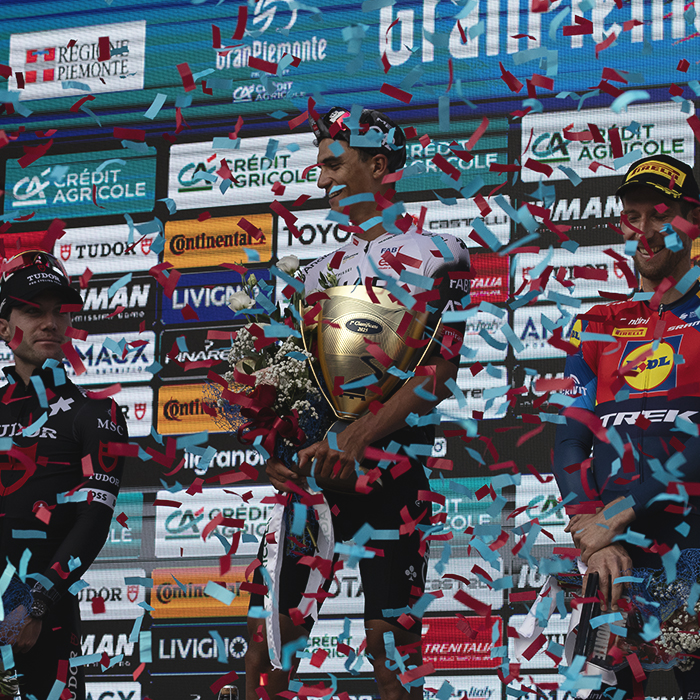 Gran Piemonte 2025 - The podium is showered in red and blue confetti as the riders are presented with their prizes
