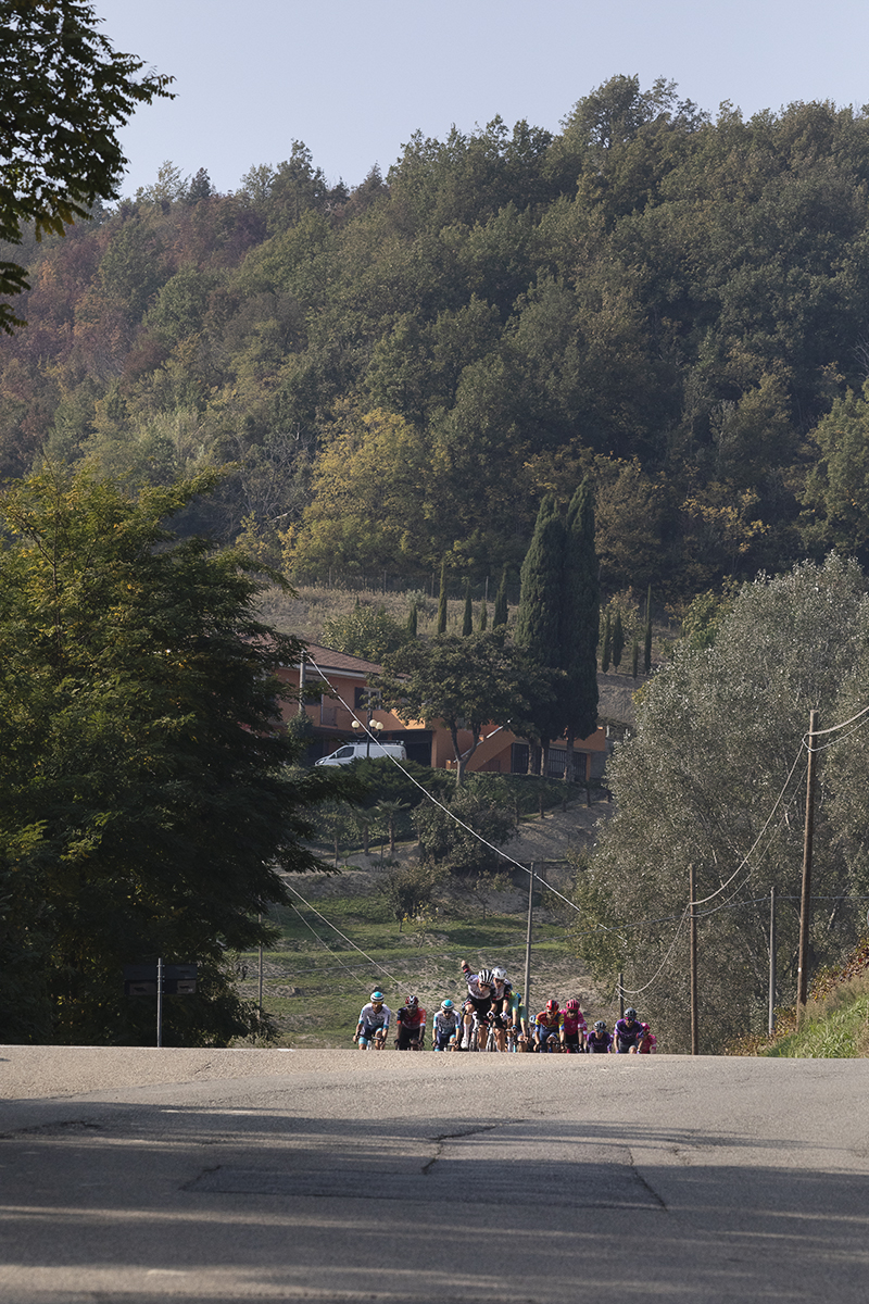 Gran Piemonte 2025 - A group of riders crest a rise in Castel Boglione