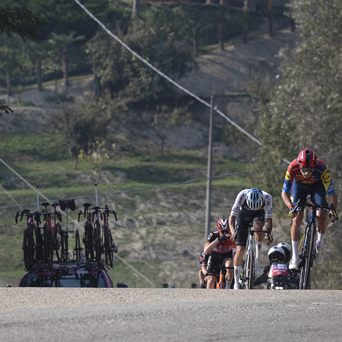 Gran Piemonte 2025 - A group of riders push onwards up an undulation in the road in Castel Boglione