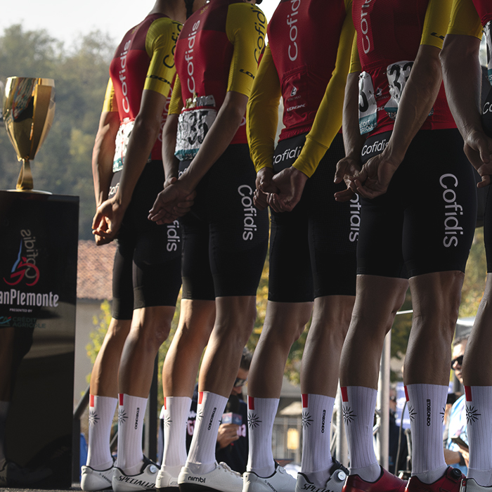 Gran Piemonte 2025 - The Cofidis team are seen from behind on the podium with the race trophy to one side