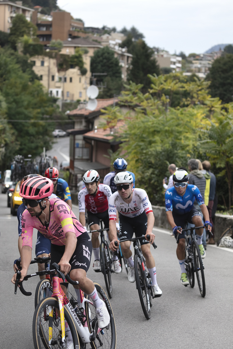 Il Lombardia 2024 - Ben Healy of EF Education - EasyPost leads a small group up a climb with the buildings of Como in the background