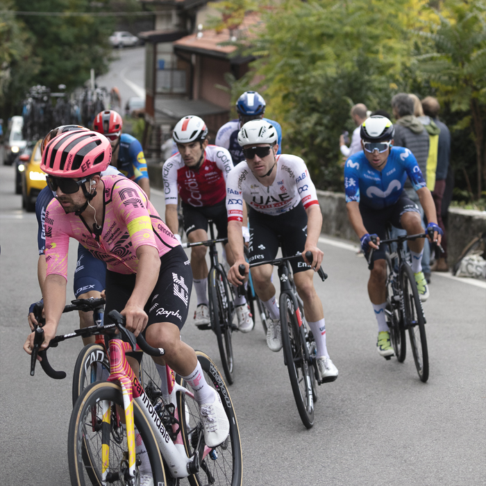 Il Lombardia 2024 - Ben Healy of EF Education - EasyPost leads a small group up a climb with the buildings of Como in the background