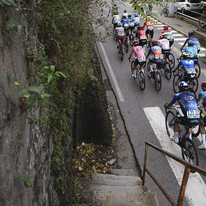 Il Lombardia 2024 - A group of riders seen from the top of old stone steps in Como
